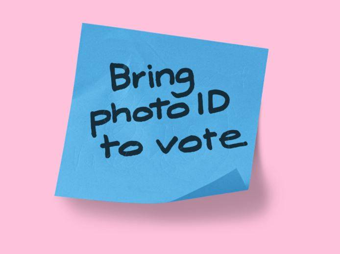 Blue post-it note, saying 'Bring photo ID to vote'