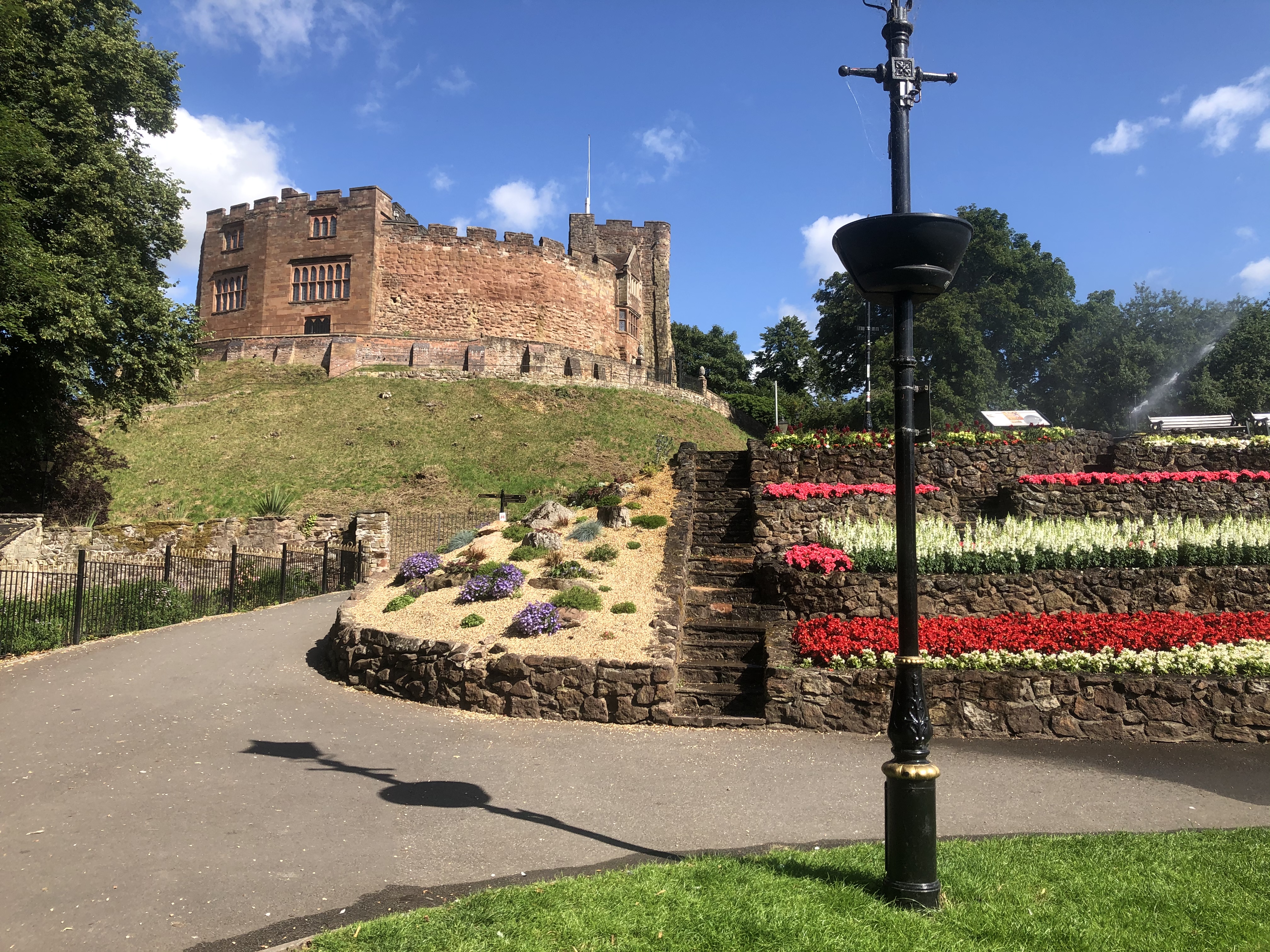 photo of a castle and flowerbeds 