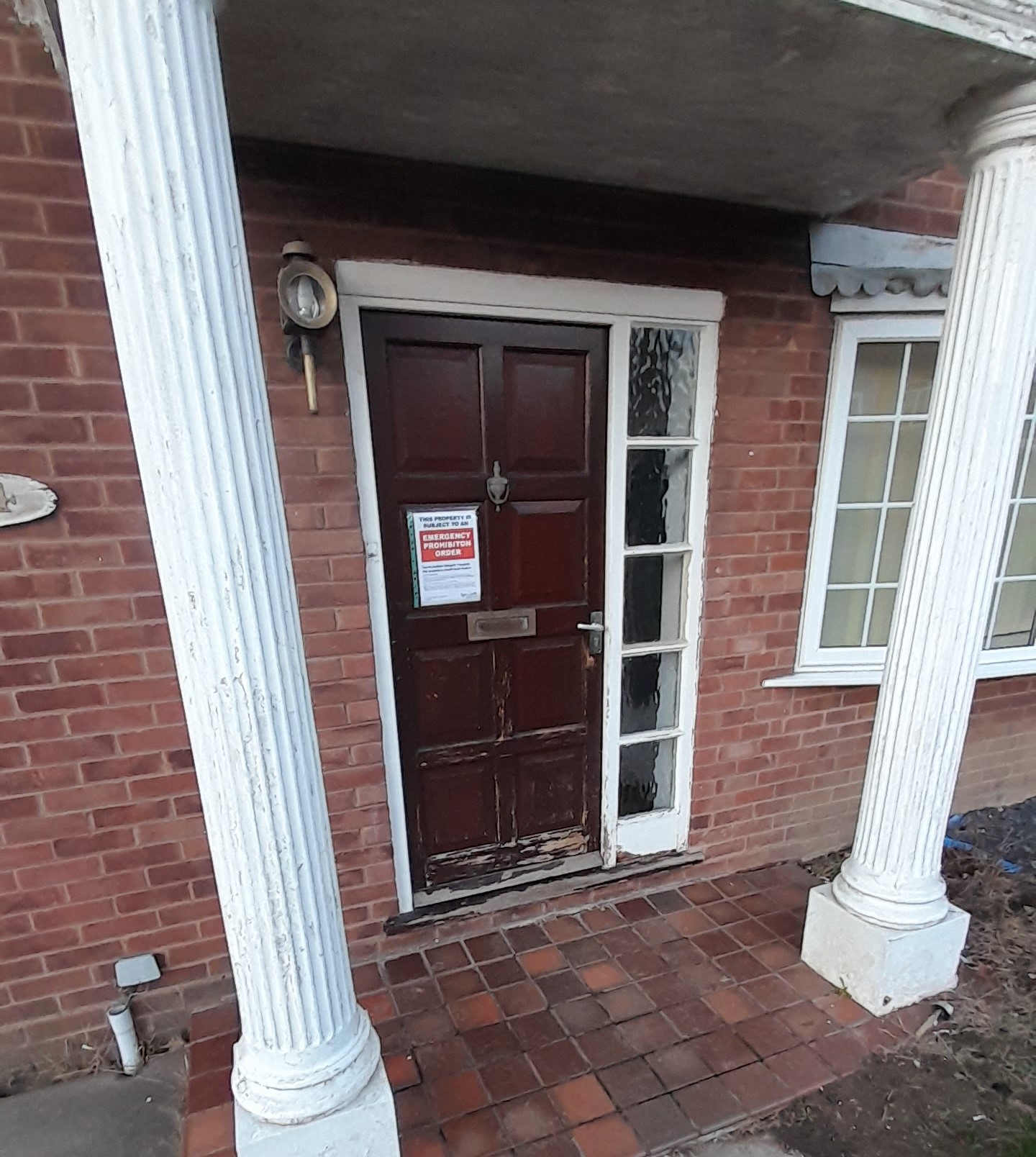 Image of front door with a notice on