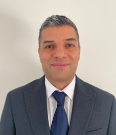 male headshot, short hair and wearing a suit