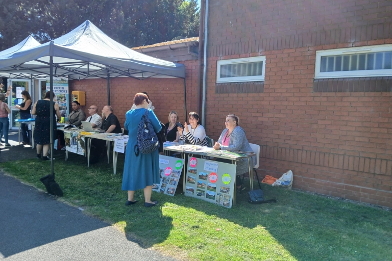 image of a gazebo and people sitting at tables 