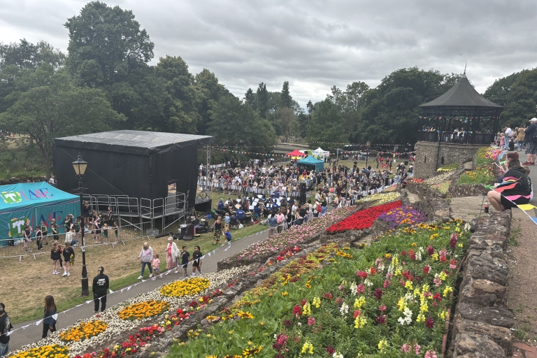 photo of a stage and gazebo on the lower lawn of Tamworth Castle Grounds with crowds of people