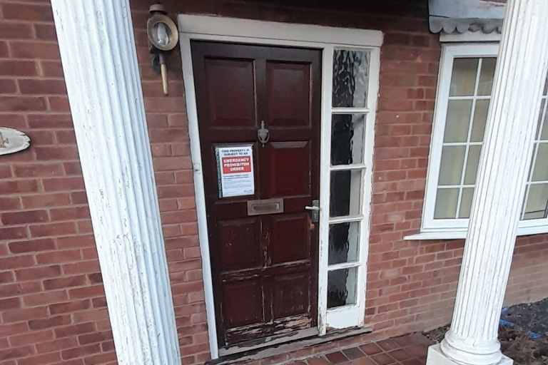 Image of front door with a notice on