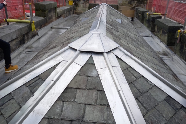 photo of a roof with metal and slate tiles