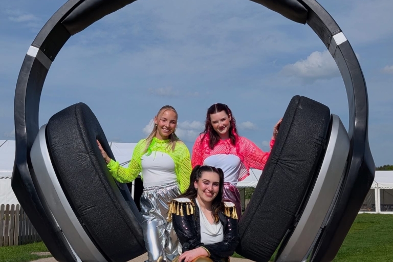 image of large headphones with 3 females wearing a yellow, pink and dark jacket 
